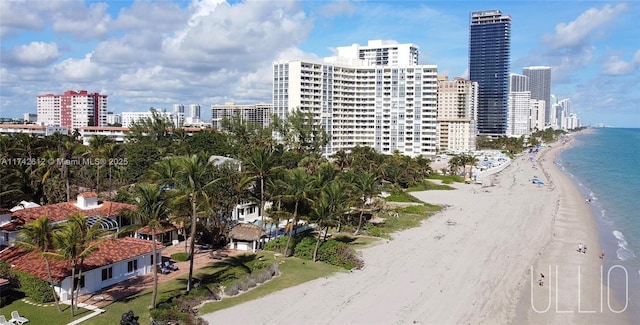 exterior space featuring a water view and a beach view