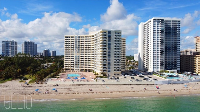 exterior space featuring a beach view and a water view