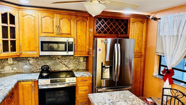 481 Ives Dairy Rd Unit 301-4, Miami, FL 33179 - kitchen featuring stainless steel appliances, tasteful backsplash, light stone countertops, and ceiling fan