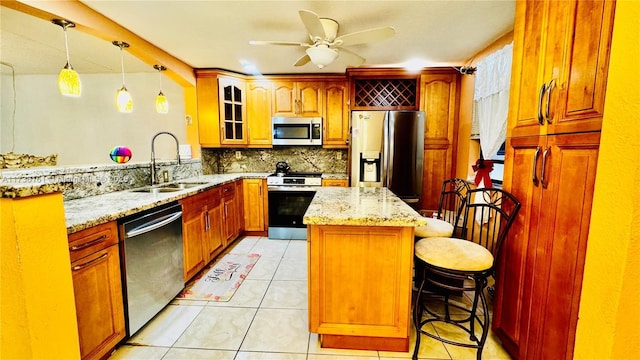 481 Ives Dairy Rd Unit 301-4, Miami, FL 33179 - kitchen featuring sink, hanging light fixtures, stainless steel appliances, a kitchen breakfast bar, and a center island