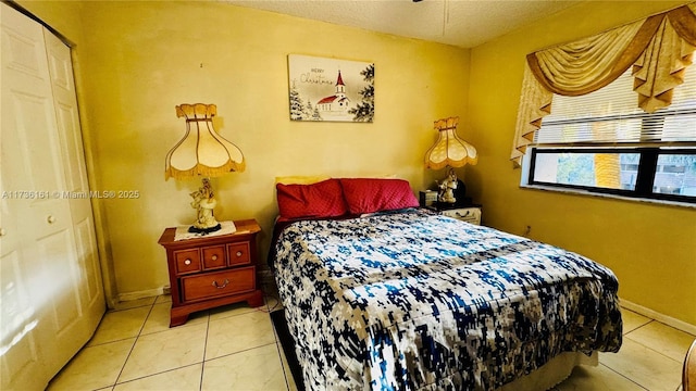 481 Ives Dairy Rd Unit 301-4, Miami, FL 33179 - bedroom with light tile patterned flooring and a textured ceiling