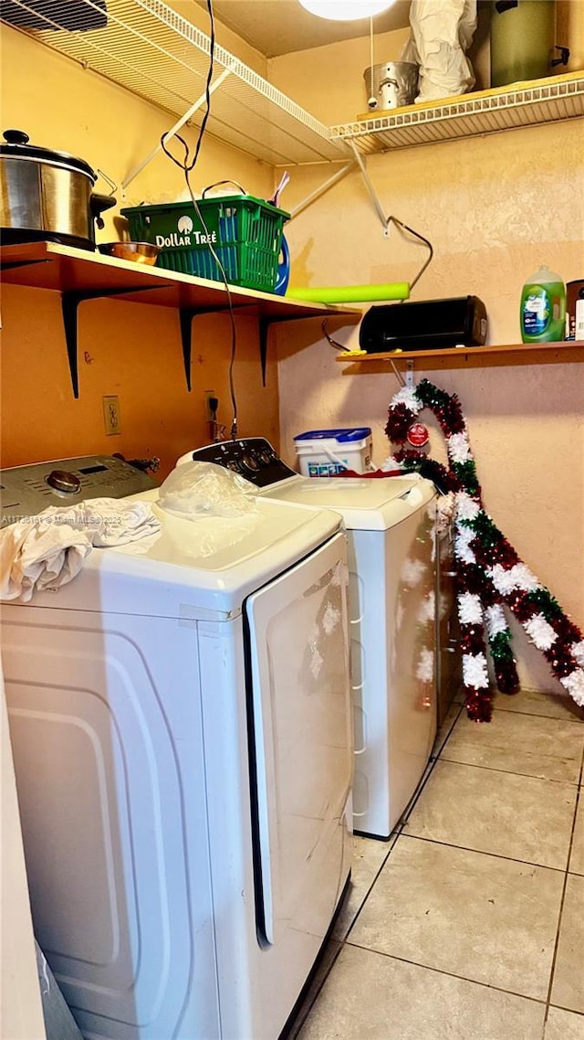 481 Ives Dairy Rd Unit 301-4, Miami, FL 33179 - laundry area with washer and dryer and light tile patterned floors