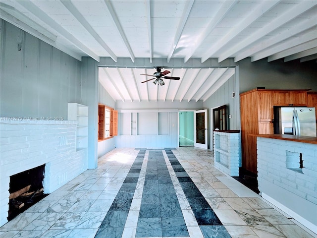 interior space with vaulted ceiling with beams and marble finish floor