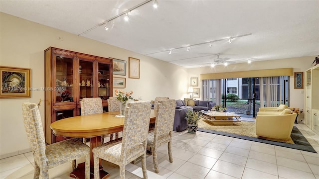 dining space with a ceiling fan and light tile patterned flooring