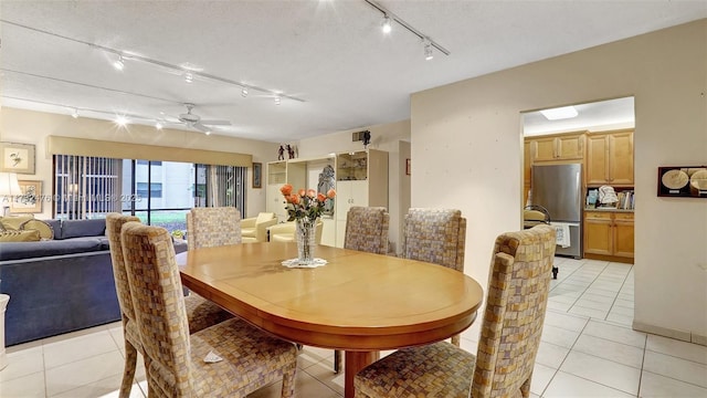 481 Ives Dairy Rd Unit 105-4, Miami, FL 33179 - dining area featuring a ceiling fan, rail lighting, and light tile patterned floors