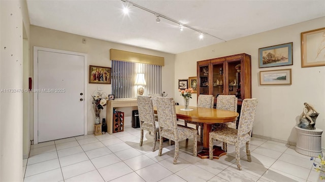 dining area featuring baseboards and light tile patterned floors