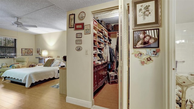 481 Ives Dairy Rd Unit 105-4, Miami, FL 33179 - bedroom with ensuite bathroom, a textured ceiling, and wood finished floors