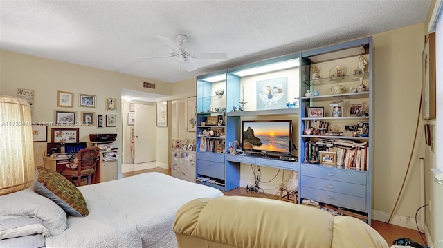 481 Ives Dairy Rd Unit 105-4, Miami, FL 33179 - bedroom with baseboards, a ceiling fan, a textured ceiling, and visible vents
