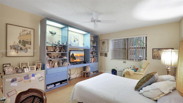 481 Ives Dairy Rd Unit 105-4, Miami, FL 33179 - bedroom featuring a textured ceiling, ceiling fan, and wood finished floors