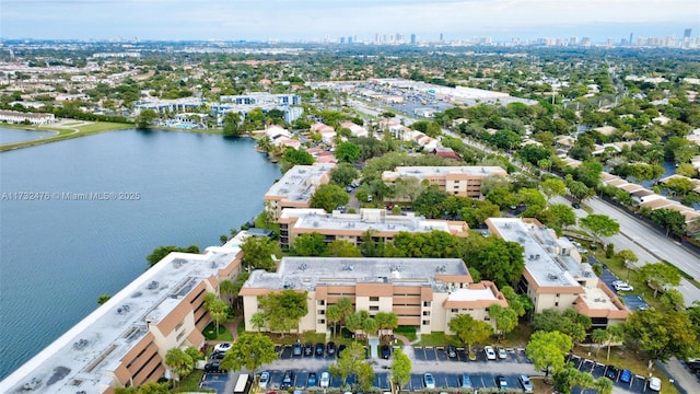 birds eye view of property featuring a view of city and a water view