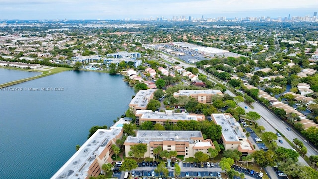 birds eye view of property with a water view and a city view