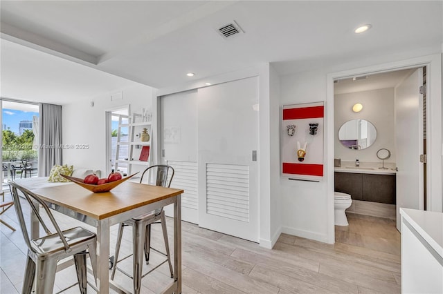 dining room with sink and light hardwood / wood-style flooring