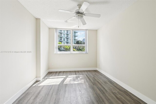 2000 N Bayshore Dr Unit 304, Miami, FL 33137 - empty room with wood finished floors, a textured ceiling, baseboards, and a ceiling fan