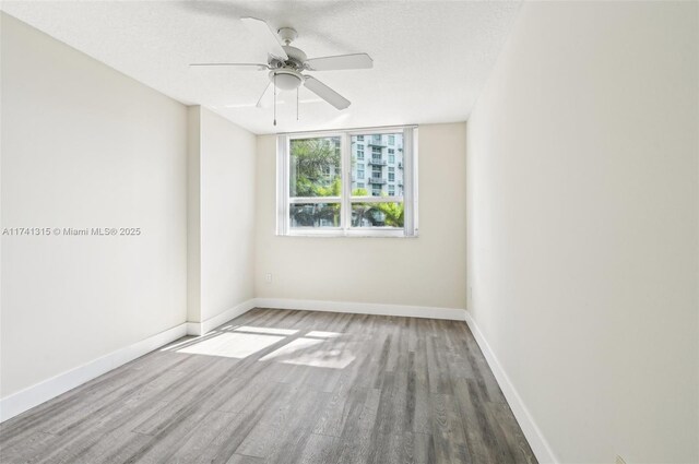 2000 N Bayshore Dr Unit 304, Miami, FL 33137 - unfurnished room featuring wood finished floors, a ceiling fan, baseboards, and a textured ceiling