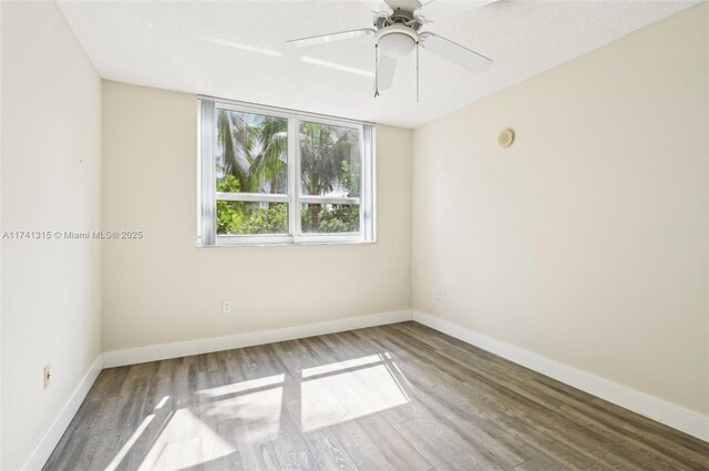 2000 N Bayshore Dr Unit 304, Miami, FL 33137 - spare room featuring wood finished floors, baseboards, and ceiling fan
