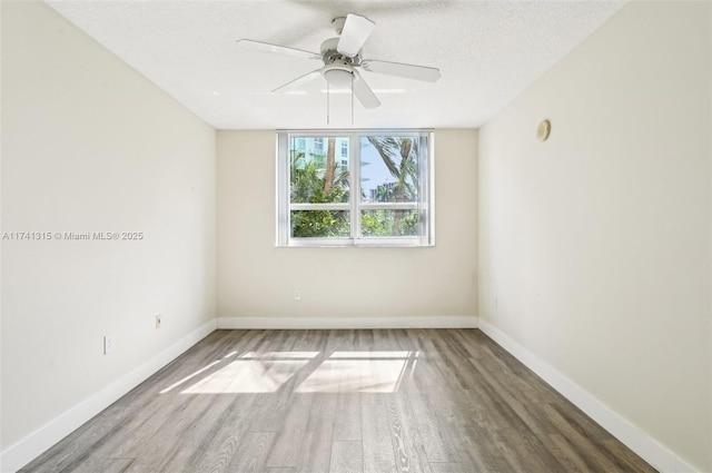 2000 N Bayshore Dr Unit 304, Miami, FL 33137 - empty room with wood finished floors, a textured ceiling, baseboards, and a ceiling fan