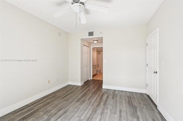 2000 N Bayshore Dr Unit 304, Miami, FL 33137 - unfurnished bedroom with wood finished floors, baseboards, ensuite bathroom, and ceiling fan