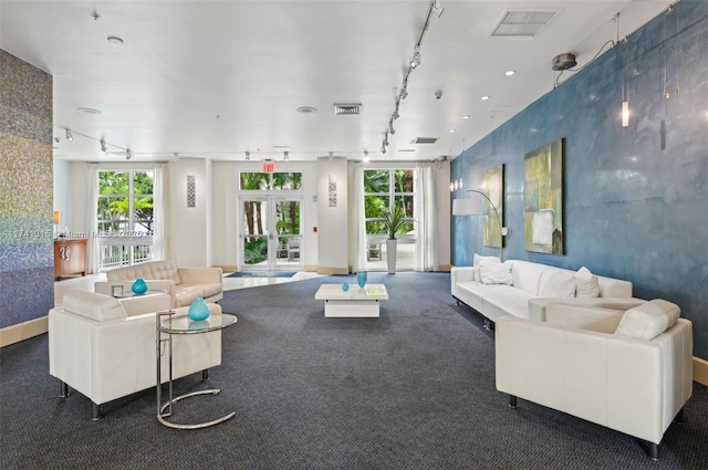 2000 N Bayshore Dr Unit 304, Miami, FL 33137 - carpeted living room with track lighting, plenty of natural light, and baseboards