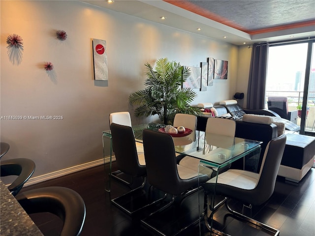 dining room with dark wood-type flooring and a textured ceiling