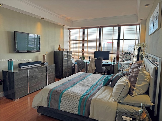 bedroom featuring hardwood / wood-style floors and crown molding