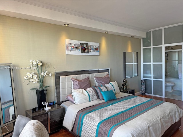bedroom with ornamental molding and dark hardwood / wood-style flooring