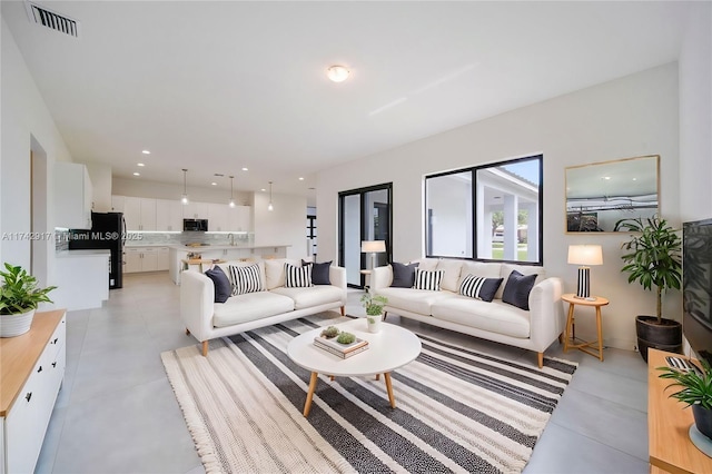 living room featuring visible vents and recessed lighting