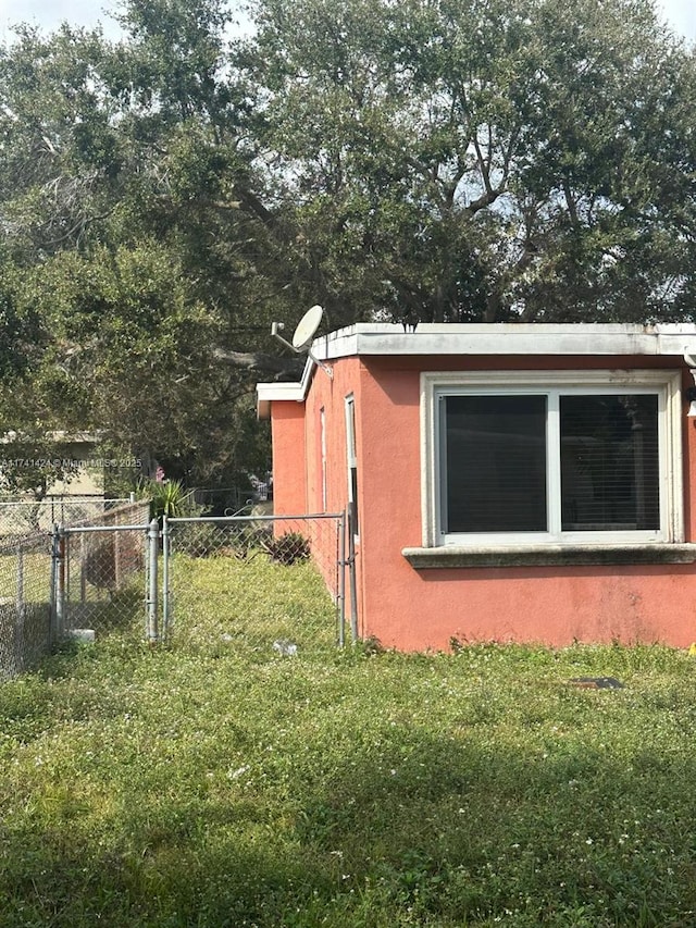 view of home's exterior with a lawn