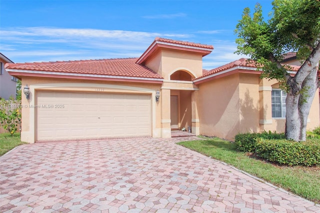 12239 SW 140th St, Miami, FL 33186 - mediterranean / spanish house with decorative driveway, stucco siding, an attached garage, and a tile roof