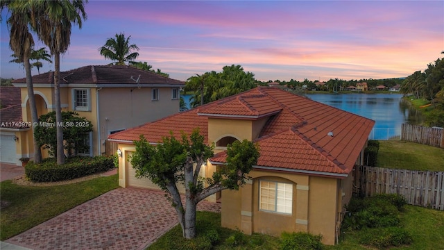12239 SW 140th St, Miami, FL 33186 - mediterranean / spanish-style home with a tiled roof, decorative driveway, a water view, and stucco siding