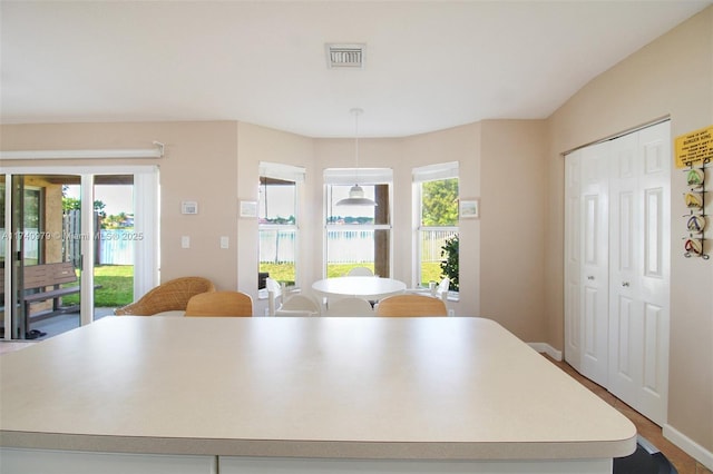 12239 SW 140th St, Miami, FL 33186 - kitchen featuring a center island, light countertops, decorative light fixtures, and baseboards