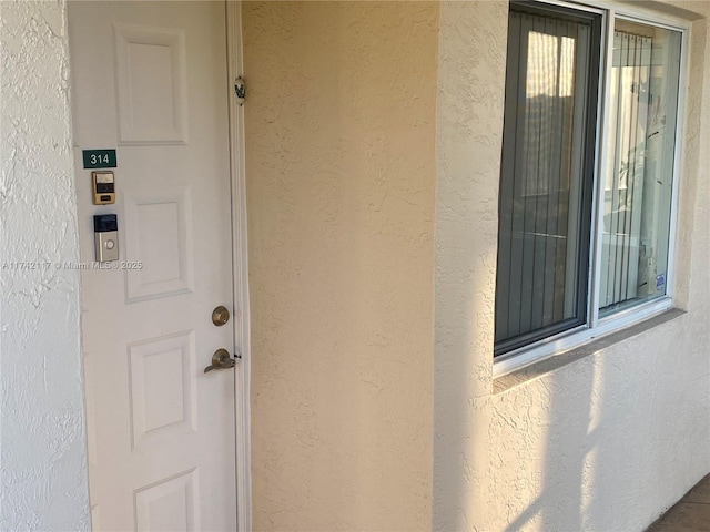 doorway to property with stucco siding