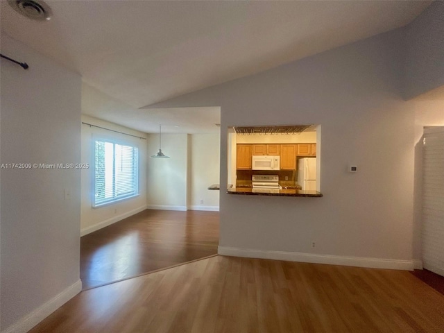 unfurnished living room with lofted ceiling, visible vents, baseboards, and dark wood-style flooring