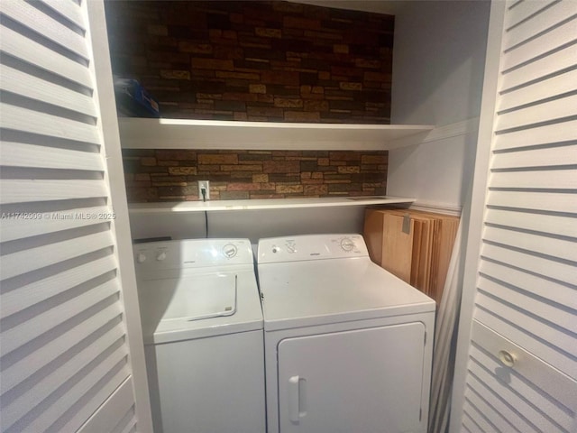 laundry room featuring washing machine and clothes dryer