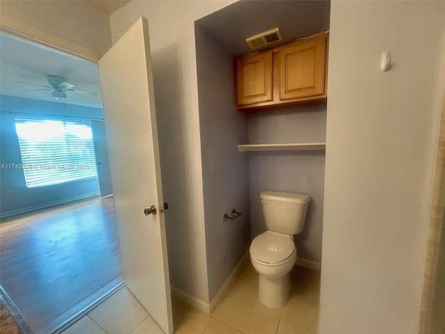 bathroom with visible vents, baseboards, toilet, ceiling fan, and tile patterned floors