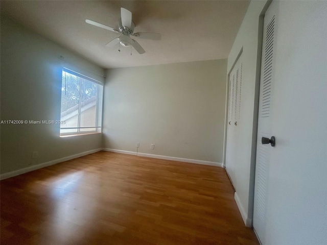 unfurnished bedroom with a ceiling fan, a closet, baseboards, and wood finished floors