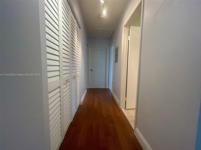 corridor featuring wood finished floors and baseboards