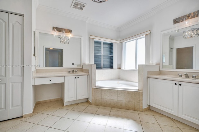 bathroom with tiled tub, ornamental molding, tile patterned floors, and vanity