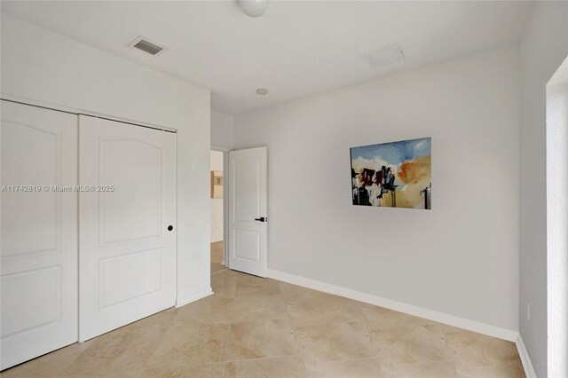 unfurnished bedroom featuring dark hardwood / wood-style flooring and a closet