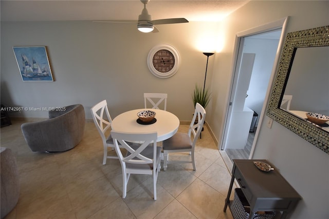 tiled dining room with ceiling fan