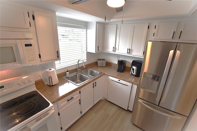 kitchen with white cabinetry, sink, white appliances, and light stone counters