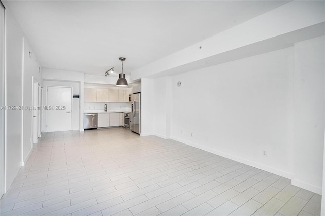 unfurnished living room featuring sink