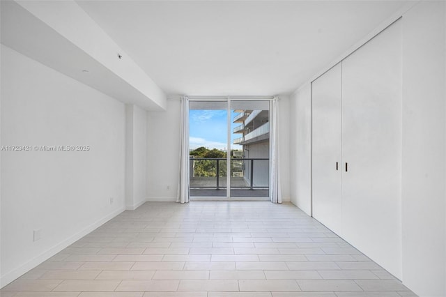 spare room featuring floor to ceiling windows