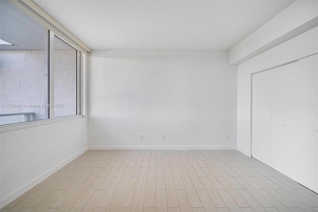 spare room with light wood-type flooring