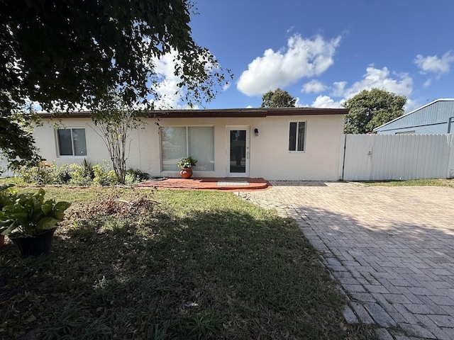 back of property with a lawn and a patio area