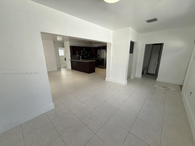 empty room with light tile patterned floors