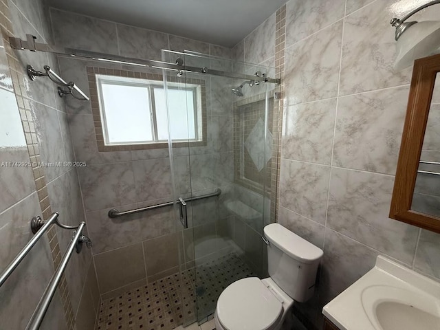 bathroom with vanity, tile walls, an enclosed shower, and toilet