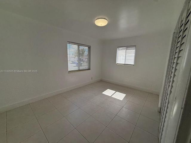 spare room featuring light tile patterned floors