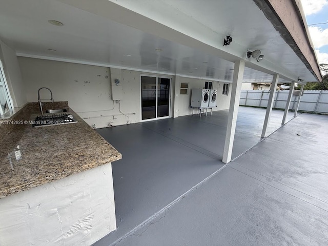 view of patio with sink and washing machine and dryer