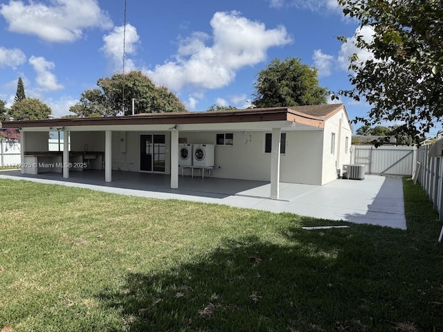 back of property with a yard, a patio area, and central air condition unit