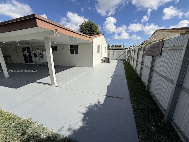 exterior space featuring separate washer and dryer, a patio, and central air condition unit